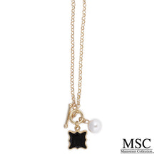 Load image into Gallery viewer, Front view of the black quatrefoil pearl necklace