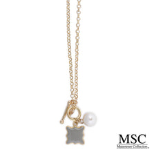 Load image into Gallery viewer, Front view of the gray quatrefoil pearl necklace