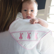 Load image into Gallery viewer, Lifestyle image of our Pink Bunny Smocked Burp Cloth