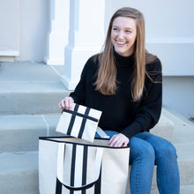 Load image into Gallery viewer, Lifestyle image of the black and white zipper pouch
