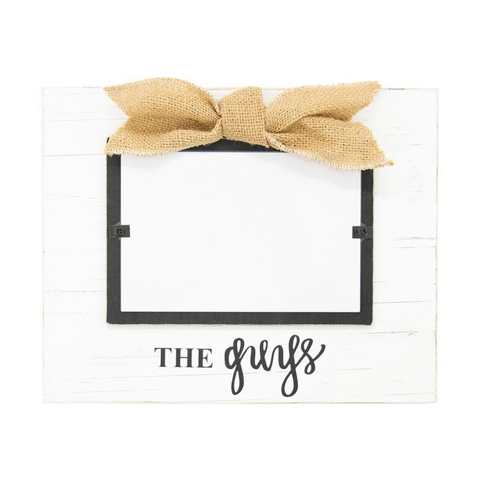White frame with burlap bow, black hand lettering says, 