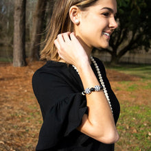 Load image into Gallery viewer, Lifestyle view of our Black Ceramic Bead Bracelet
