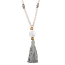 Load image into Gallery viewer, Natural wood bead necklace with gray tassel featuring a large ceramic bead in the center
