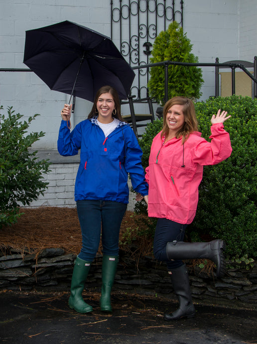 Lifestyle image of blue and pink raincoats