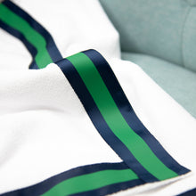 Load image into Gallery viewer, Close up lifestyle image of the green and navy bath wrap trim
