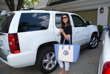 Load image into Gallery viewer, Woman heading out of the house with her blue gingham weekender tote
